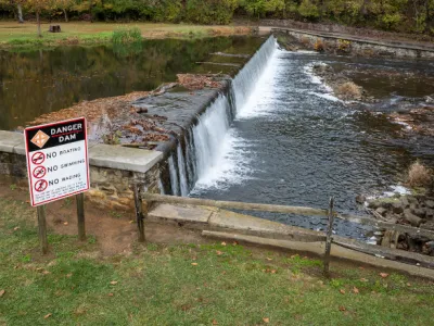 Low-Head Dam with Warning Sign in Front